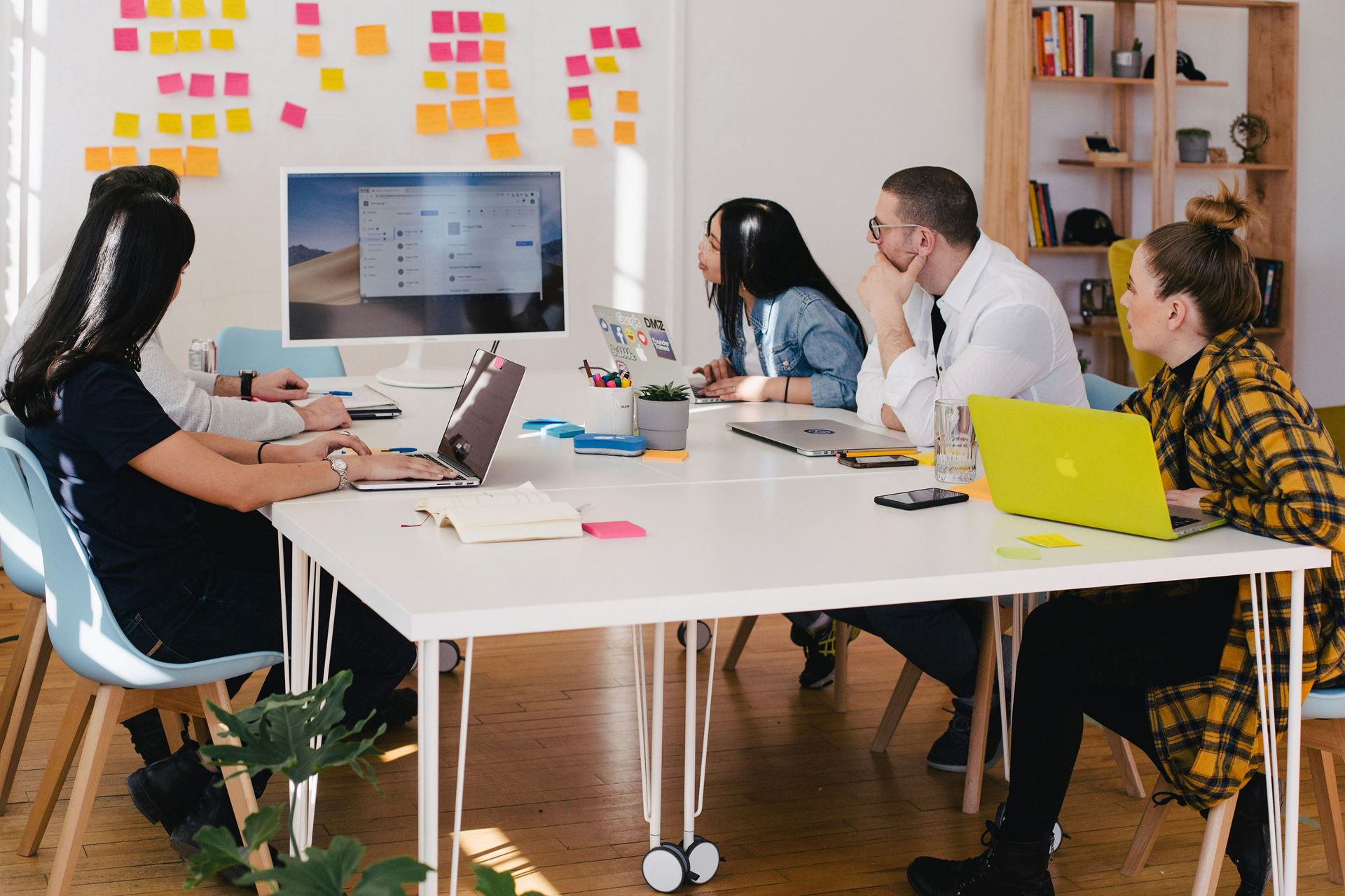 A group of people working together around a desk